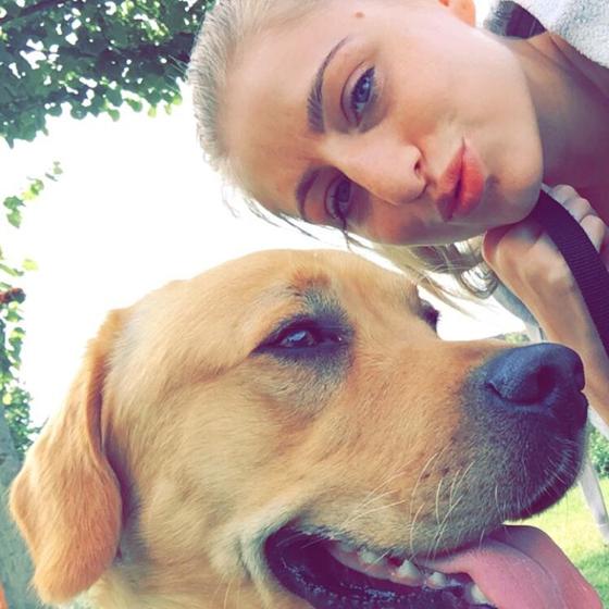 Charlotte cheek to cheek with her Labrador, Ollie, in the park